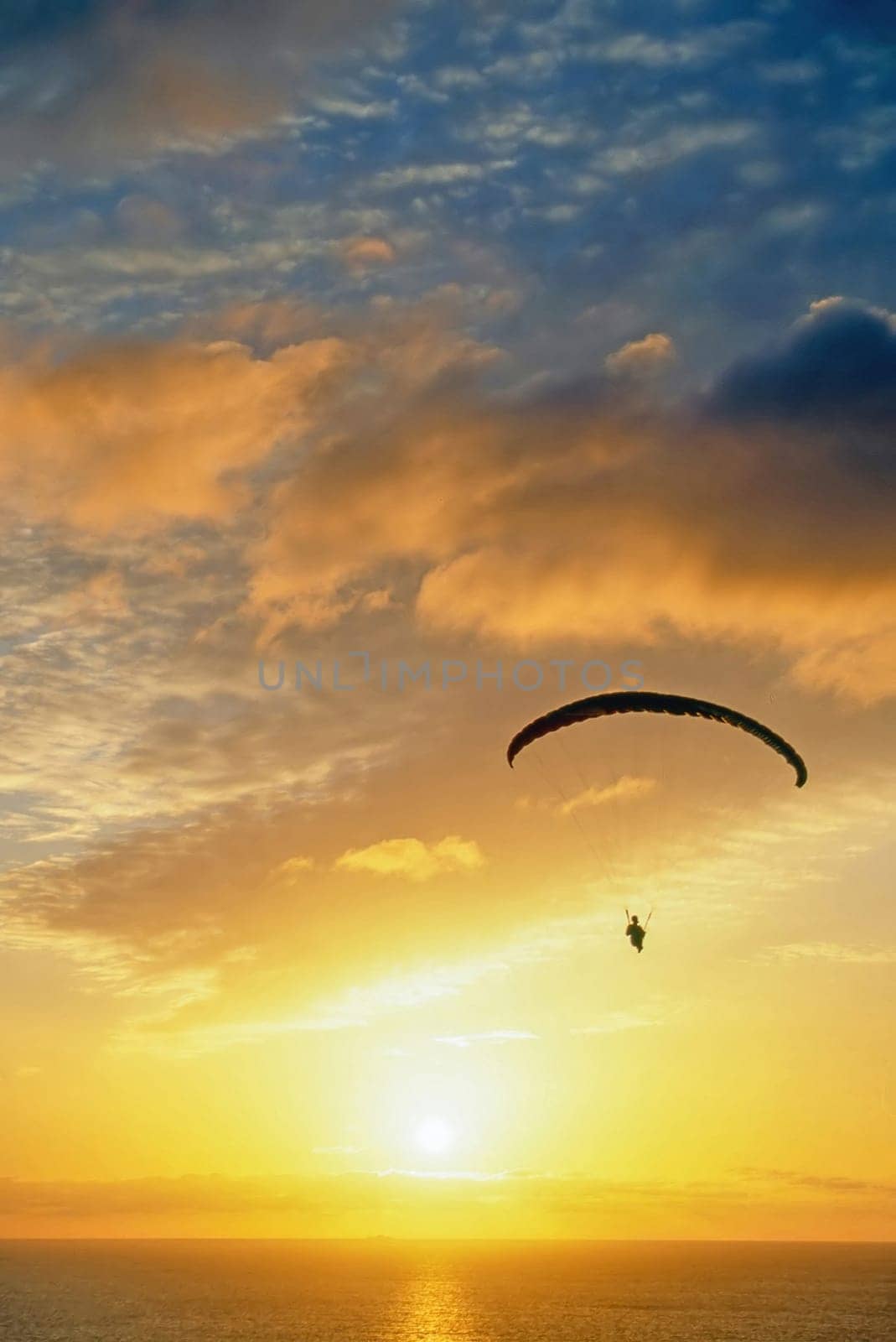 Glider over Pacific Ocean at sunset