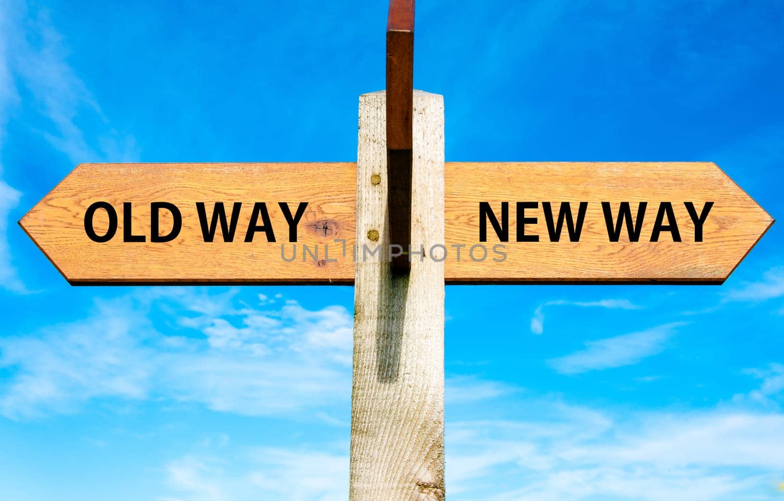 Blank wooden signpost with two arrows over clear blue sky with copy space, just add your text here