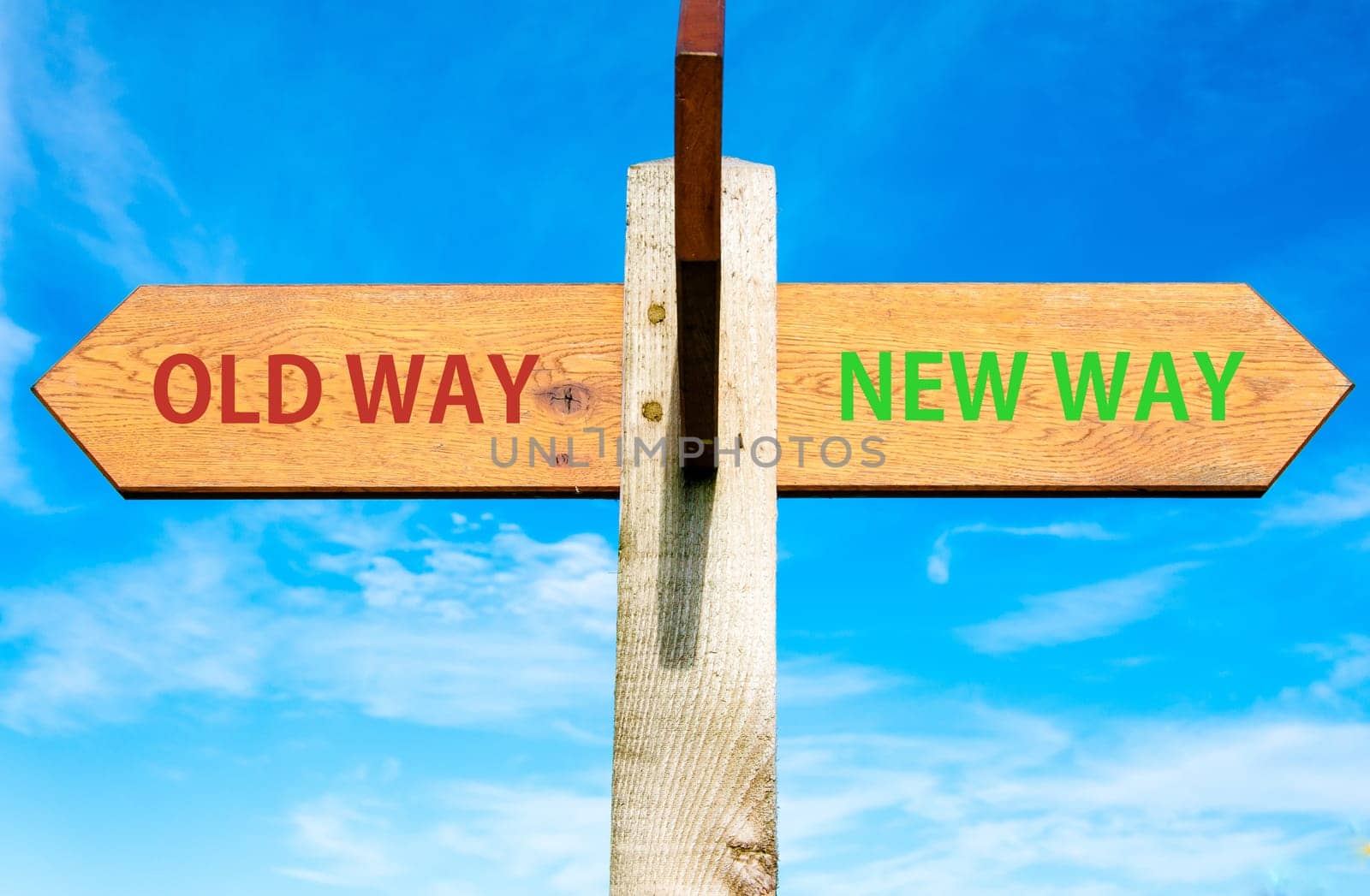 Blank wooden signpost with two arrows over clear blue sky with copy space, just add your text here