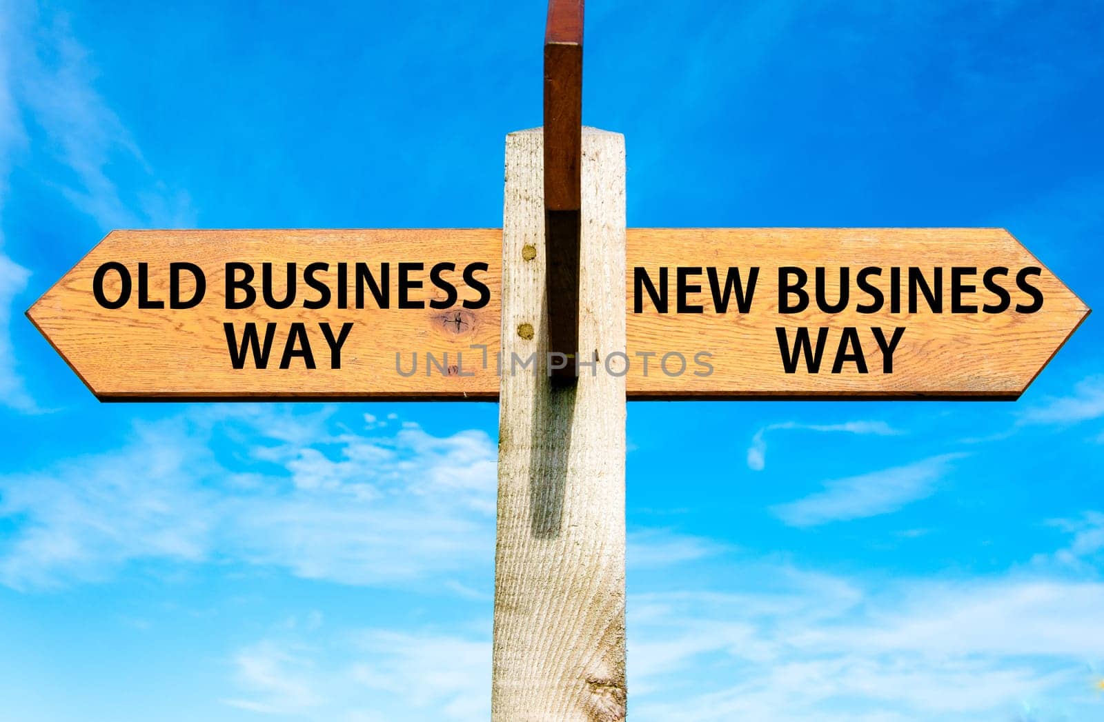 Blank wooden signpost with two arrows over clear blue sky with copy space, just add your text here