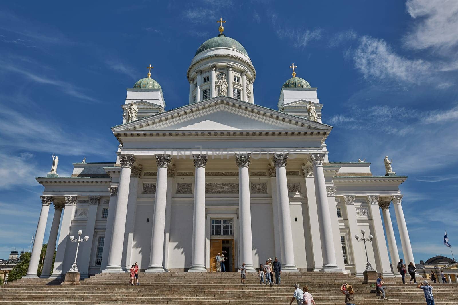 HELSINKI, FINLAND - JULY 10, 2017: Visitors entering the Cathedral of the Diocese of Helsinki, finnish Evangelical Lutheran church, located in the neighborhood of Kruununhaka in Helsinki, Finland