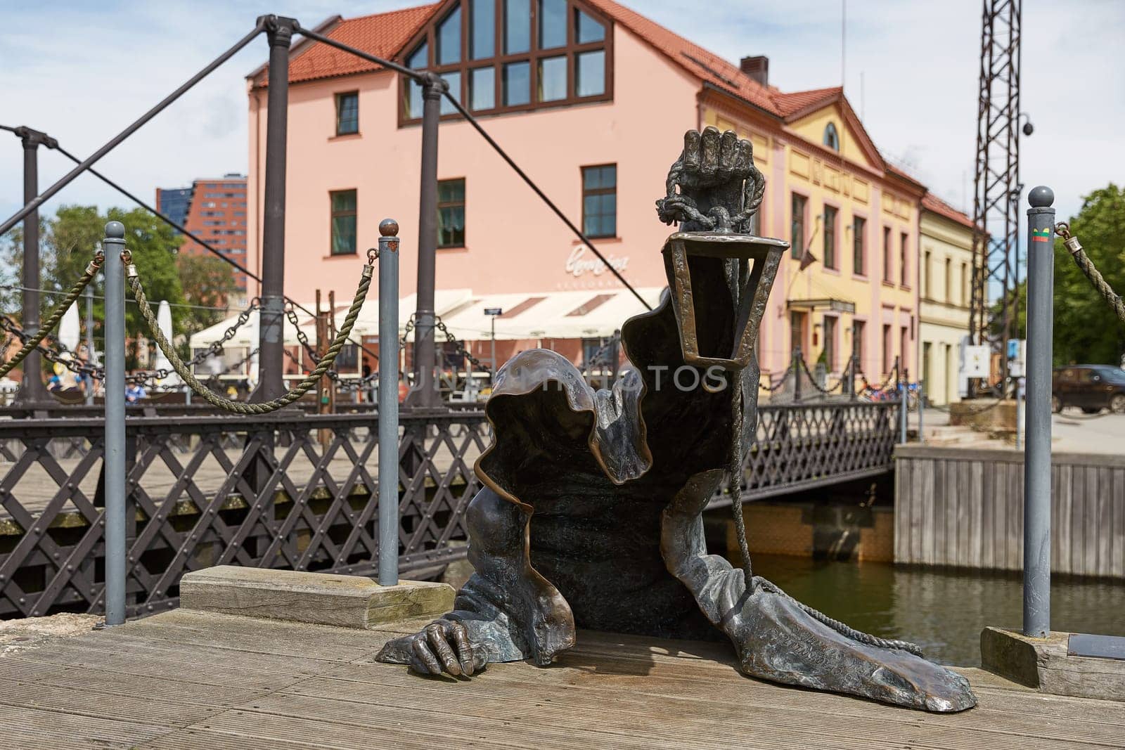 KLAIPEDA, LITHUANIA - JULY 05, 2017: The Black Ghost bronzed sculpture (designed by Svajunas Jurkus and Sergejus Plotnikovas). Danes river quay. Klaipeda Old Town residential district. Lithuania
