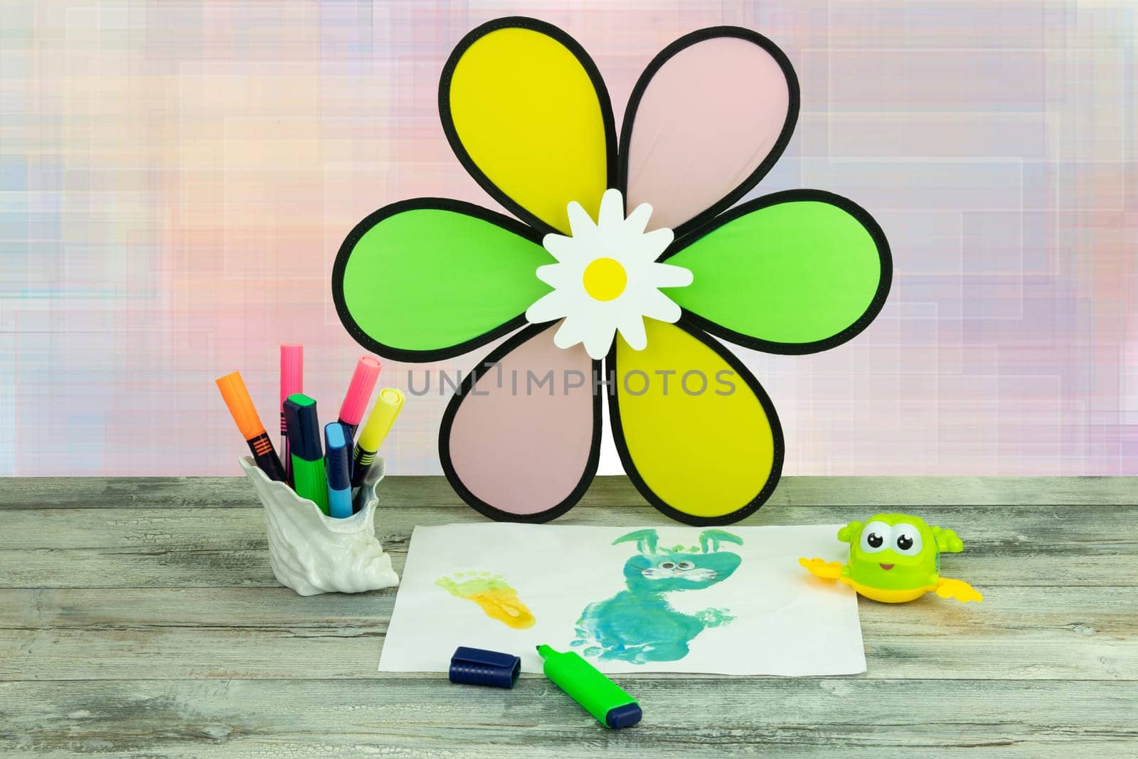 Happy childrens day. Workplace from child is painting his mother a bunny picture.