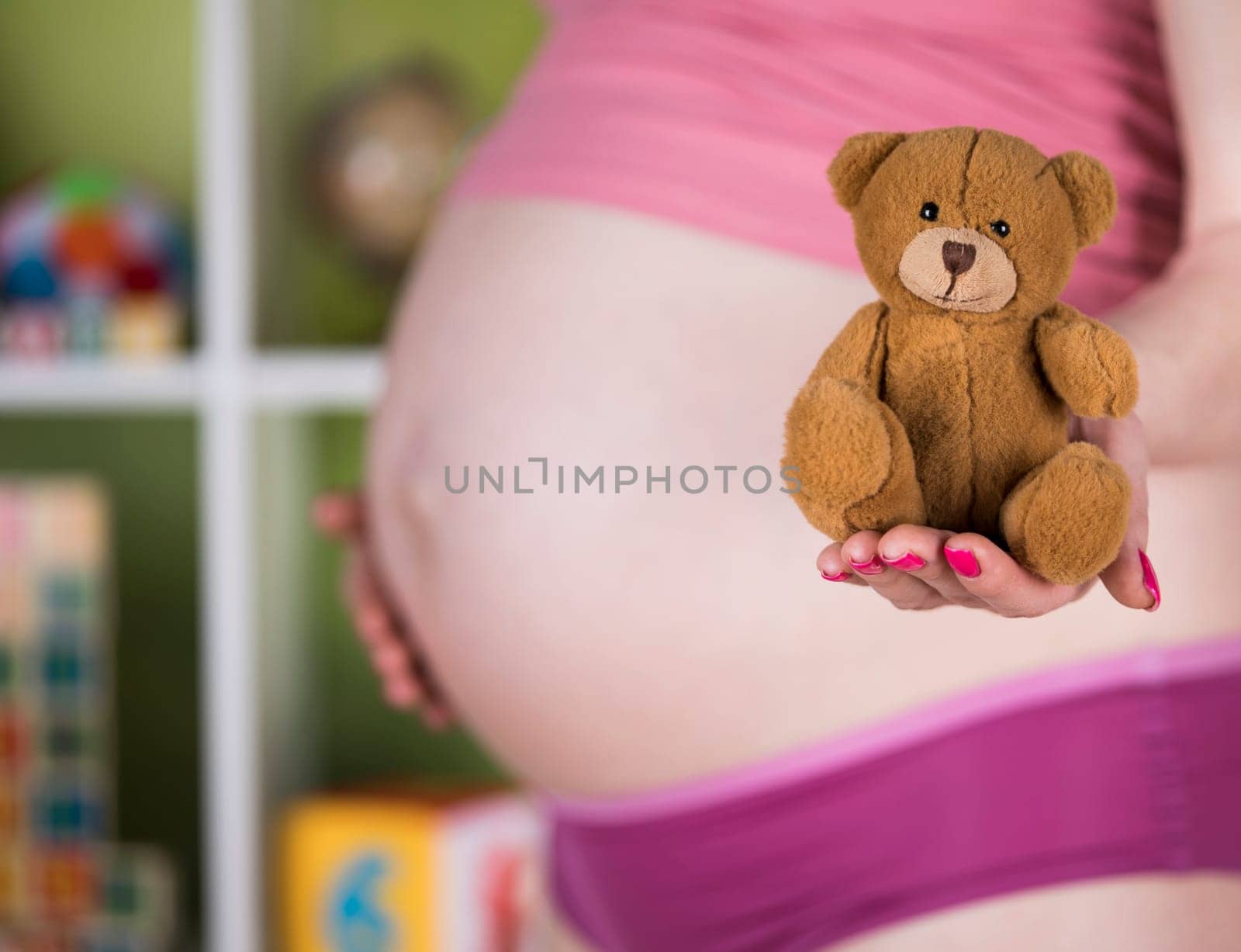 Teddy bear toy, pregnant woman