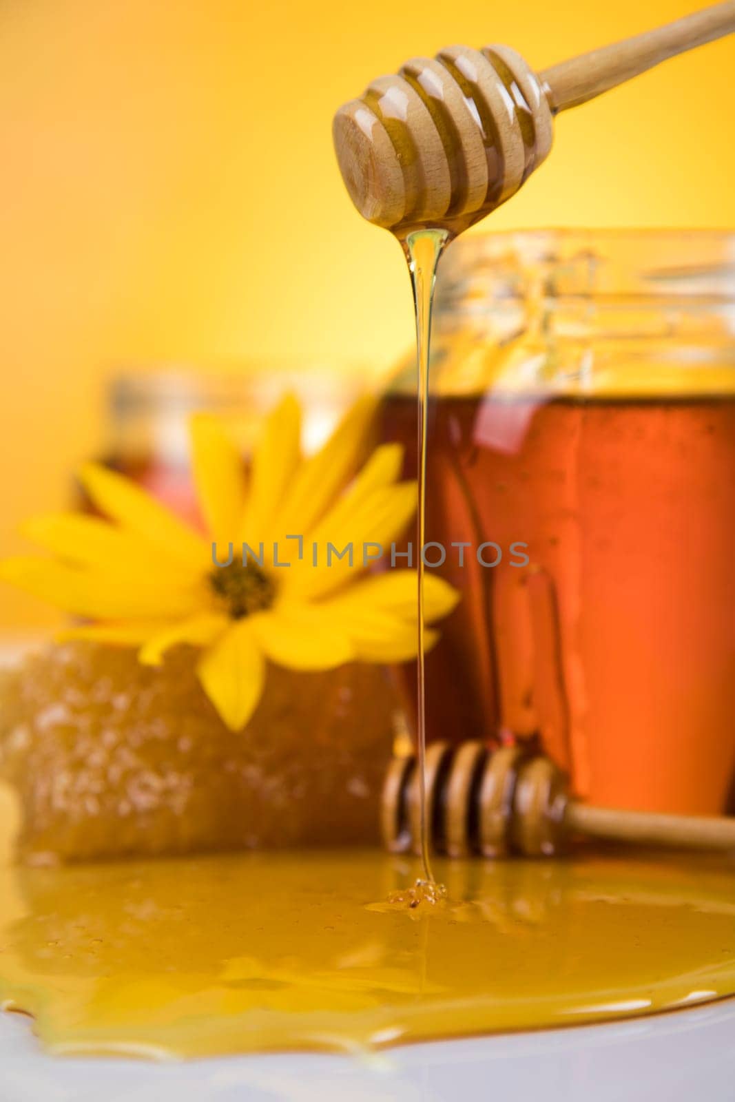 Honey jar, flower with dipper and flowing honey