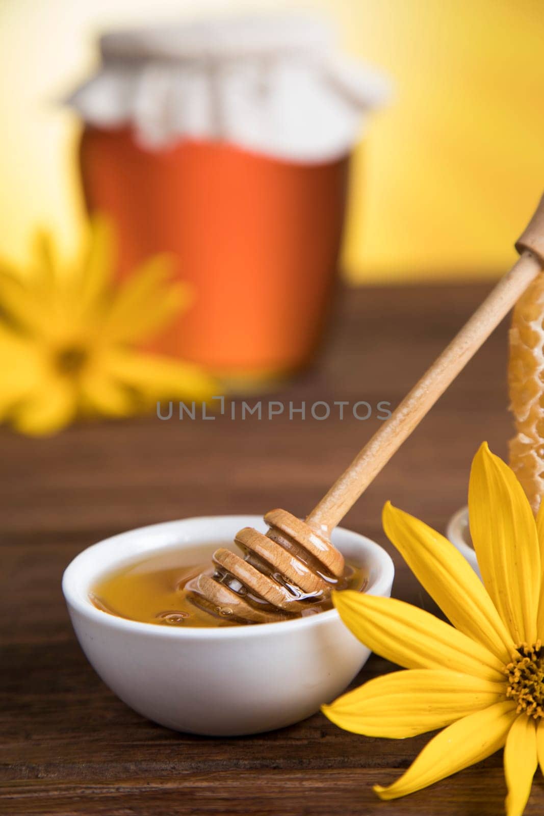 Sweet honey in the comb, glass jar on wooden background