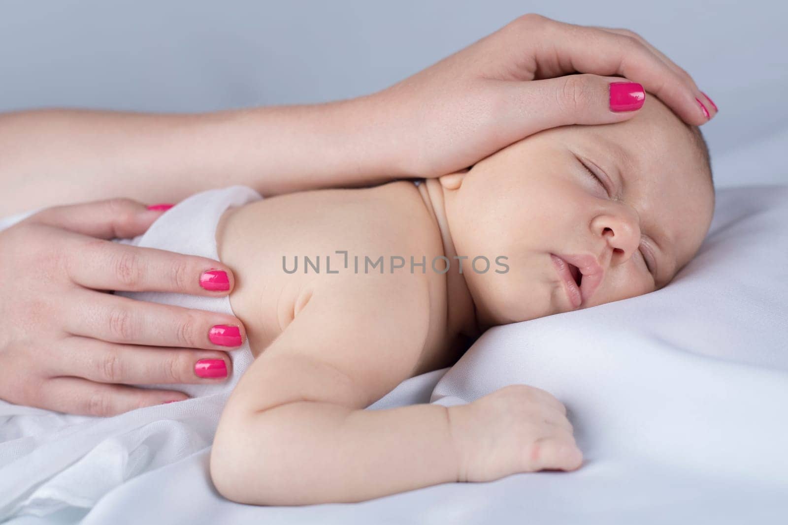 Newborn baby hand holding mother