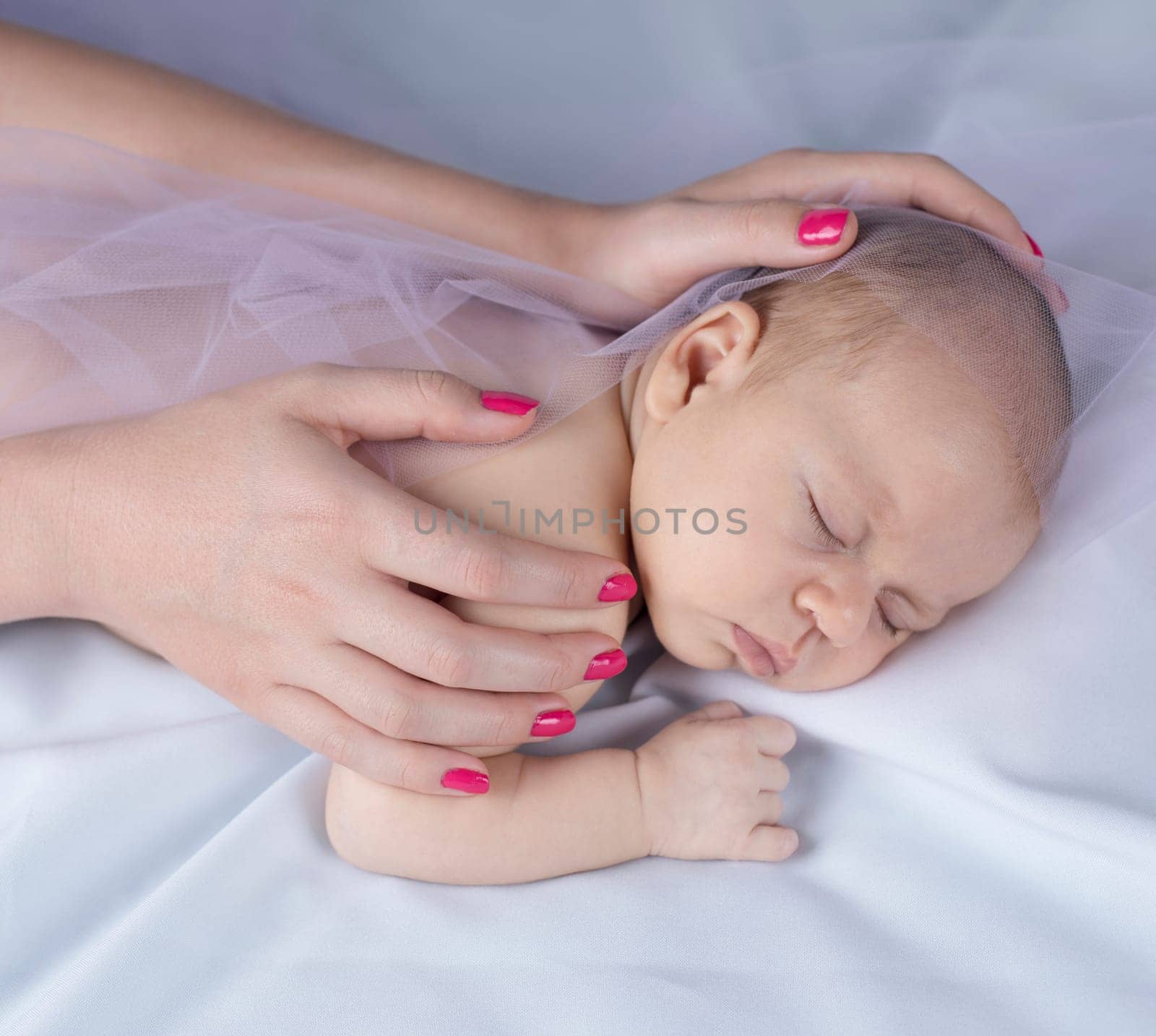 Newborn baby hand holding mother