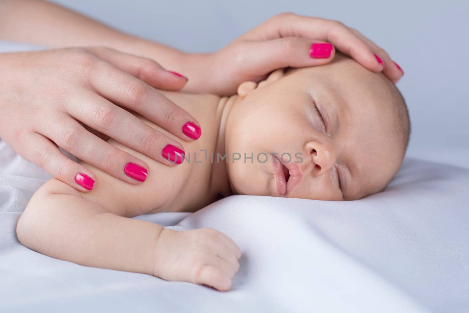 Newborn baby hand holding mother