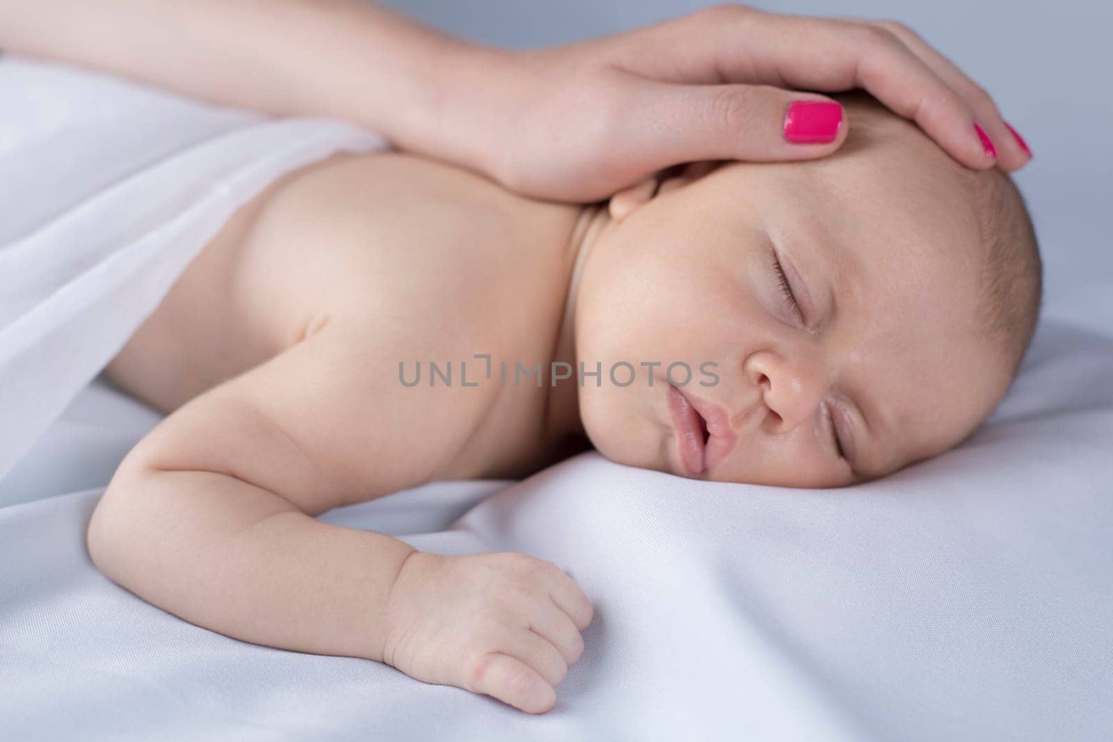 Newborn baby hand holding mother