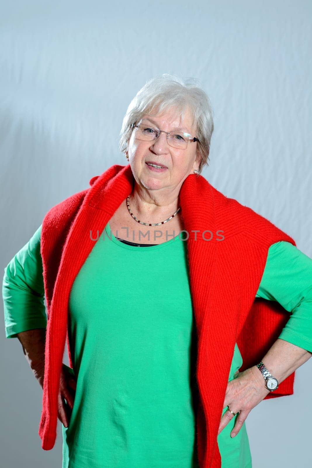 gray haired female senior in front of gray background