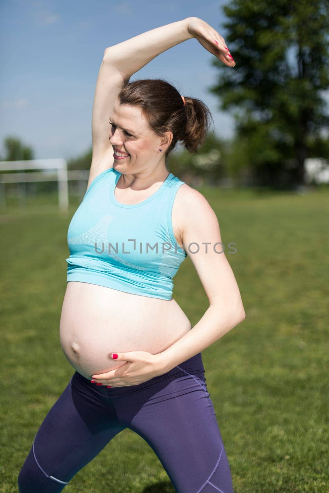 Beautiful pregnant woman at fitness gym relaxed