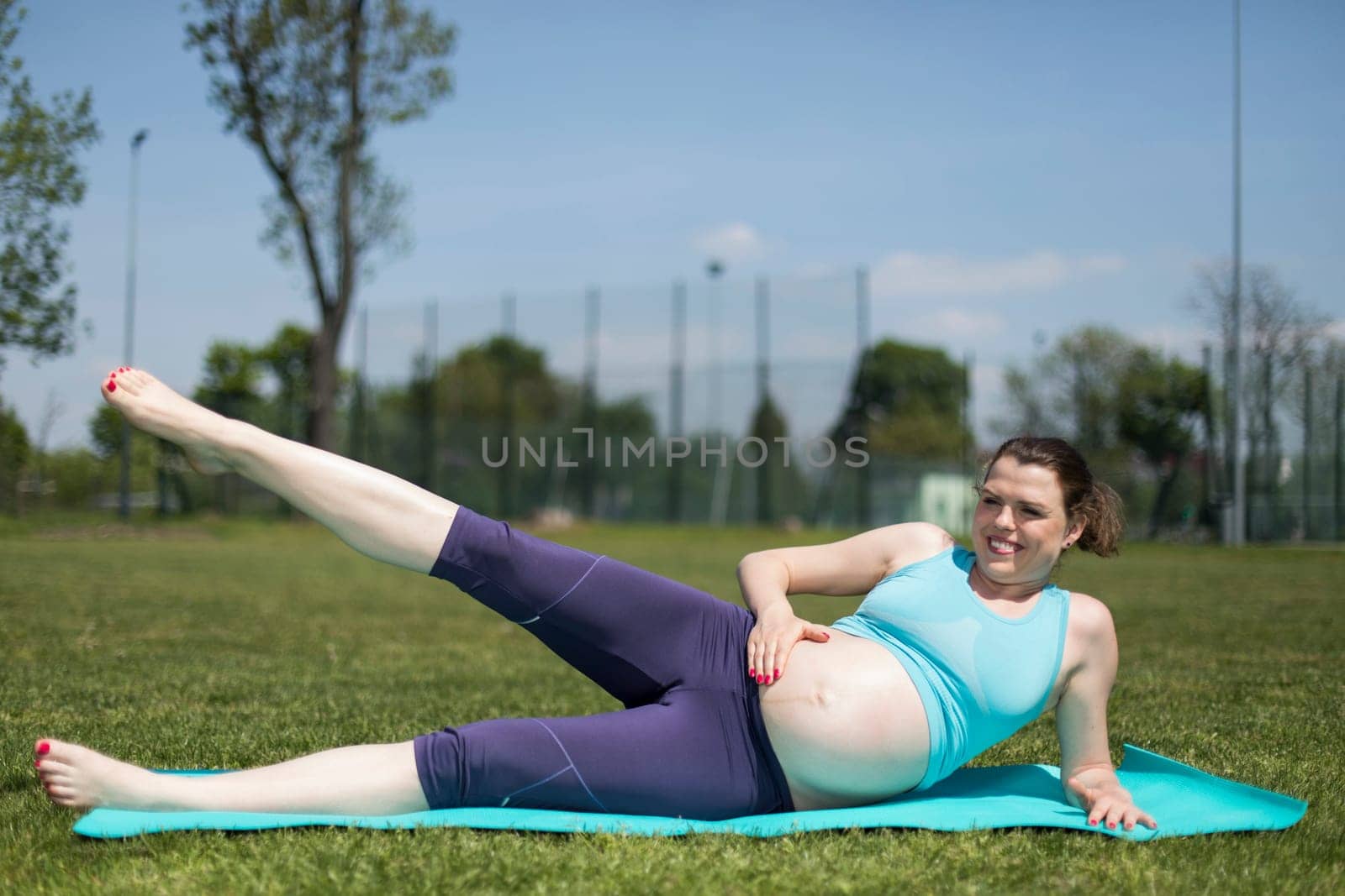 Beautiful pregnant woman at fitness gym relaxed
