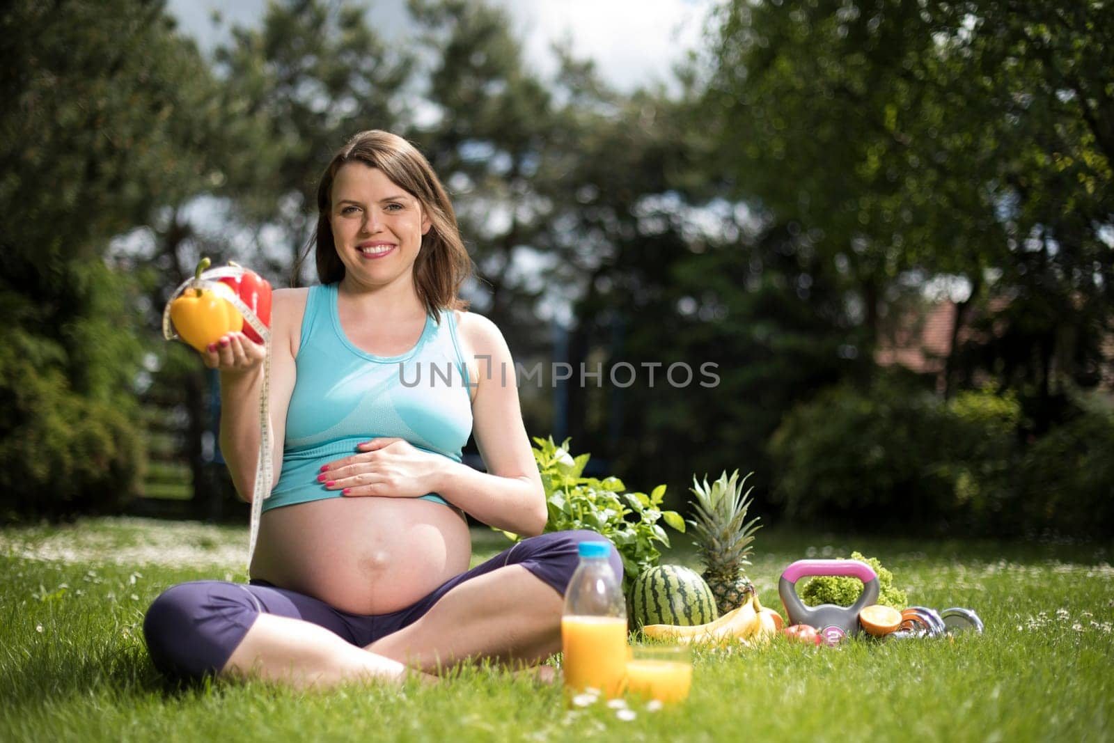 Beautiful pregnant woman at fitness gym relaxed