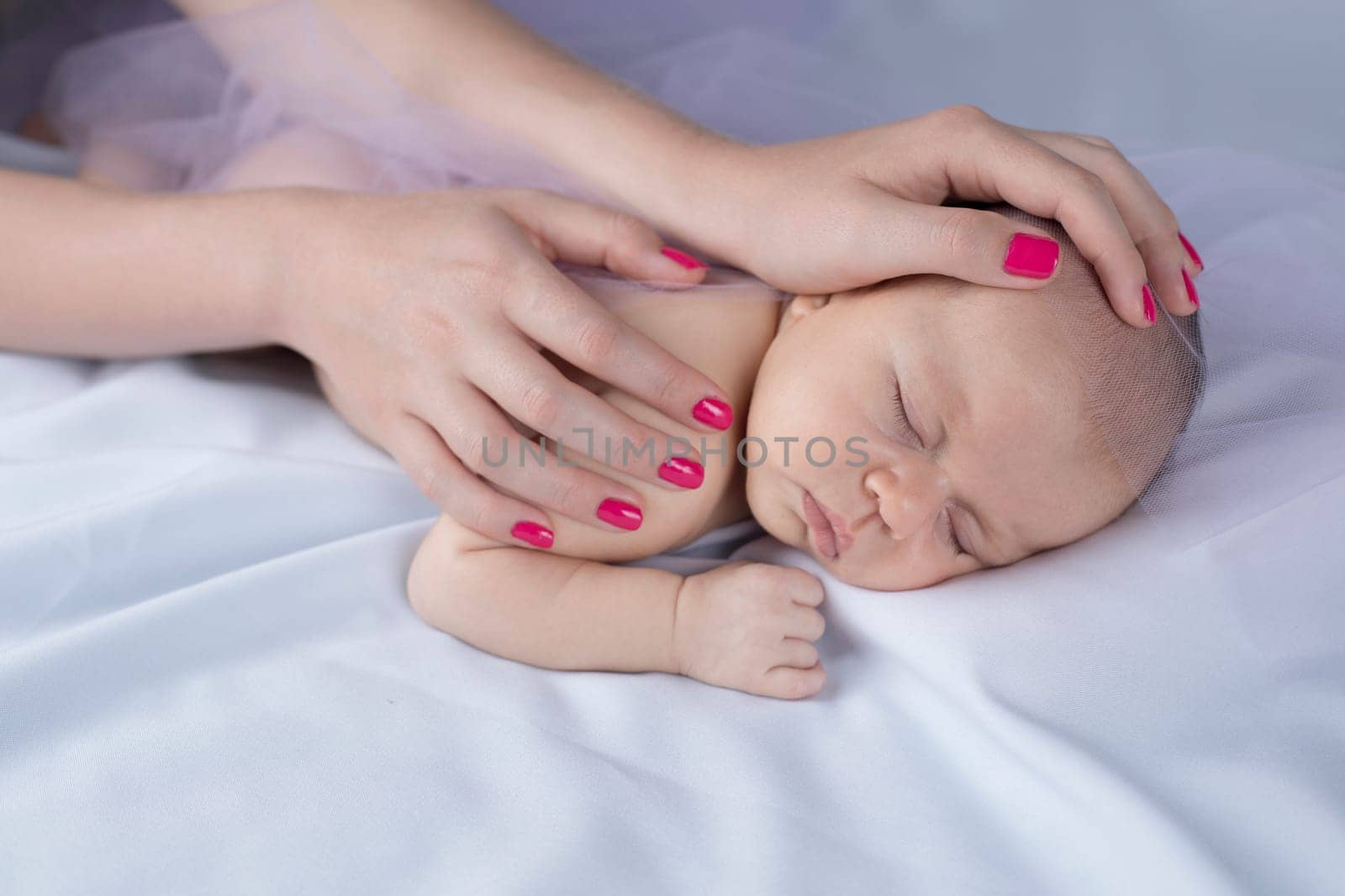 Newborn baby hand holding mother