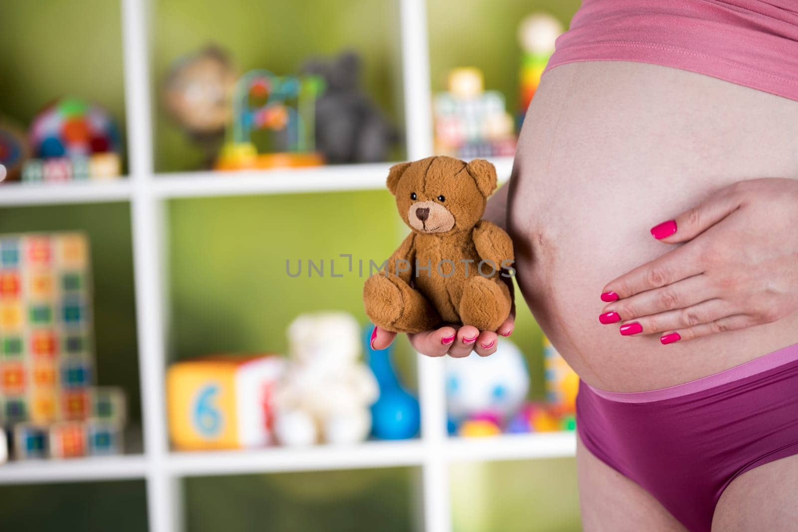 Teddy bear toy, pregnant woman
