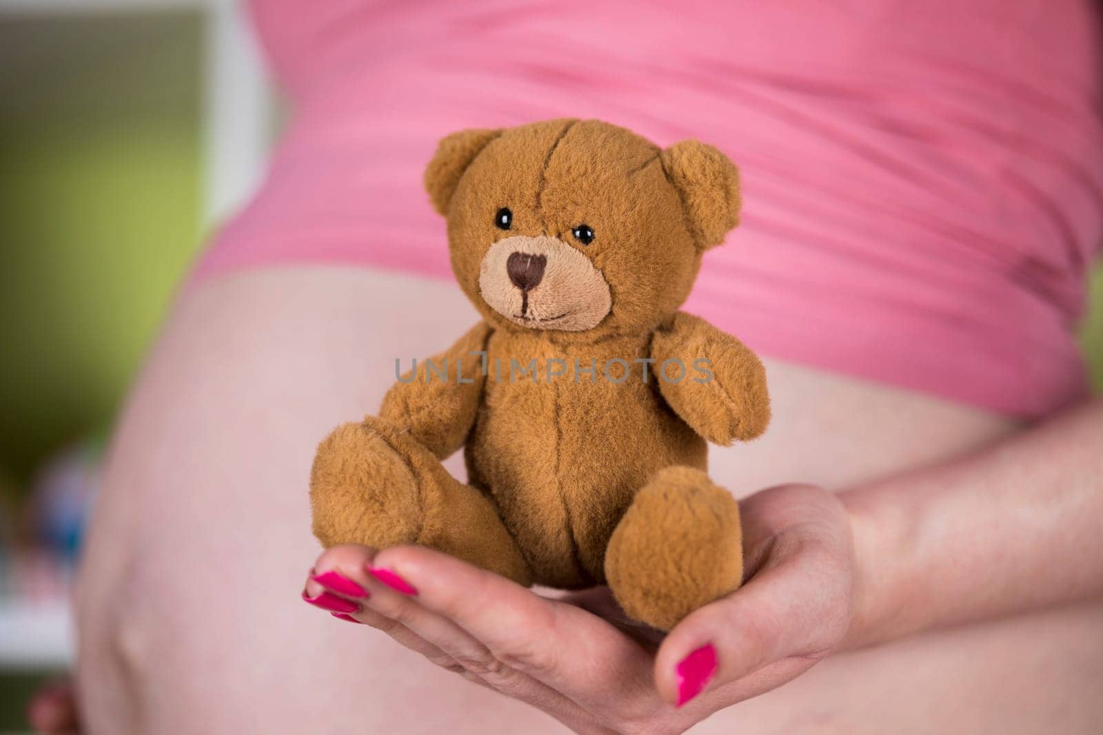 Teddy bear toy, pregnant woman