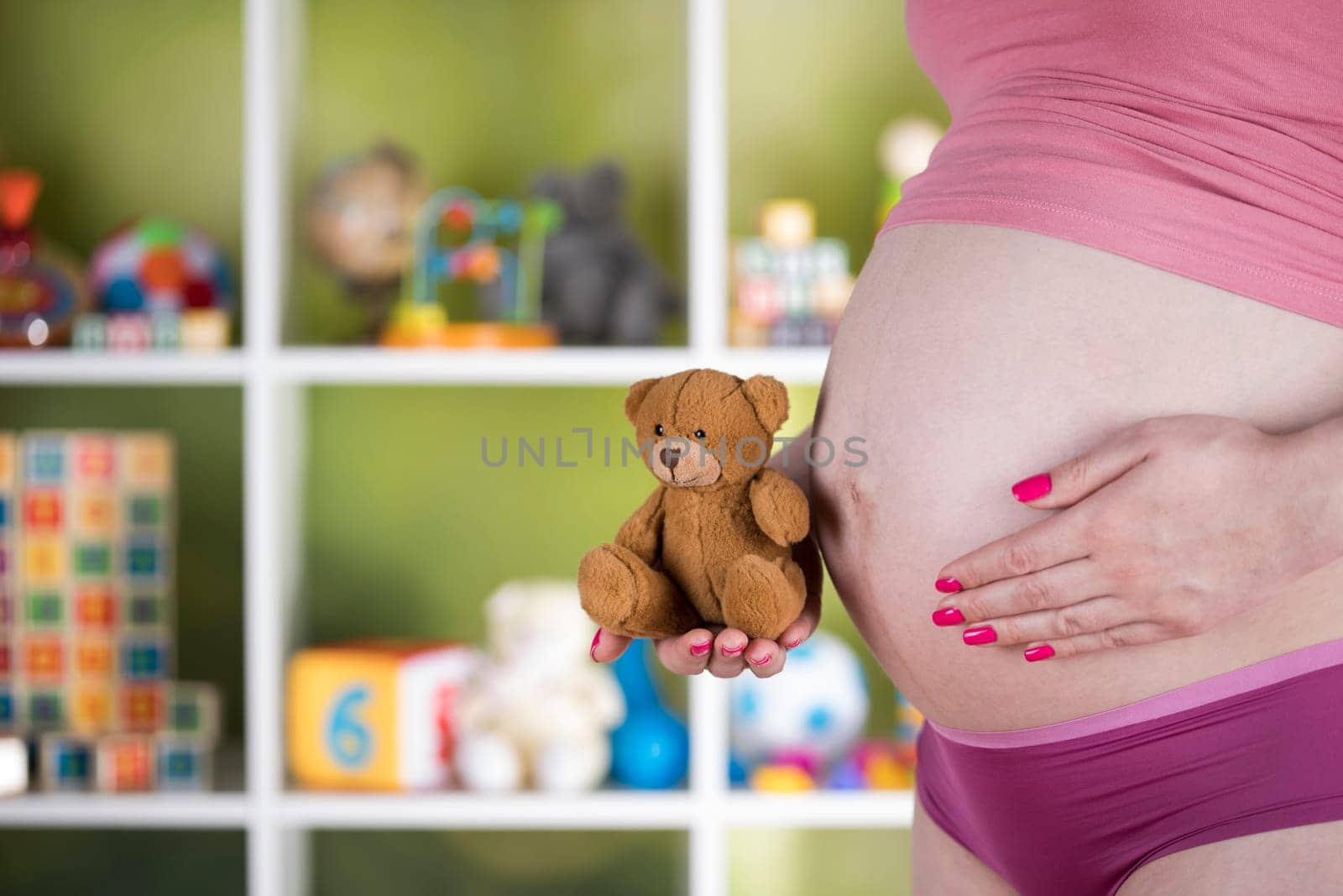 Teddy bear toy, pregnant woman