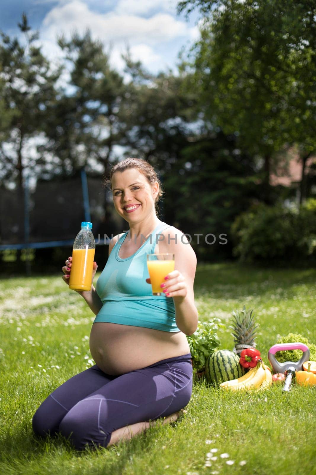 Beautiful pregnant woman at fitness gym relaxed