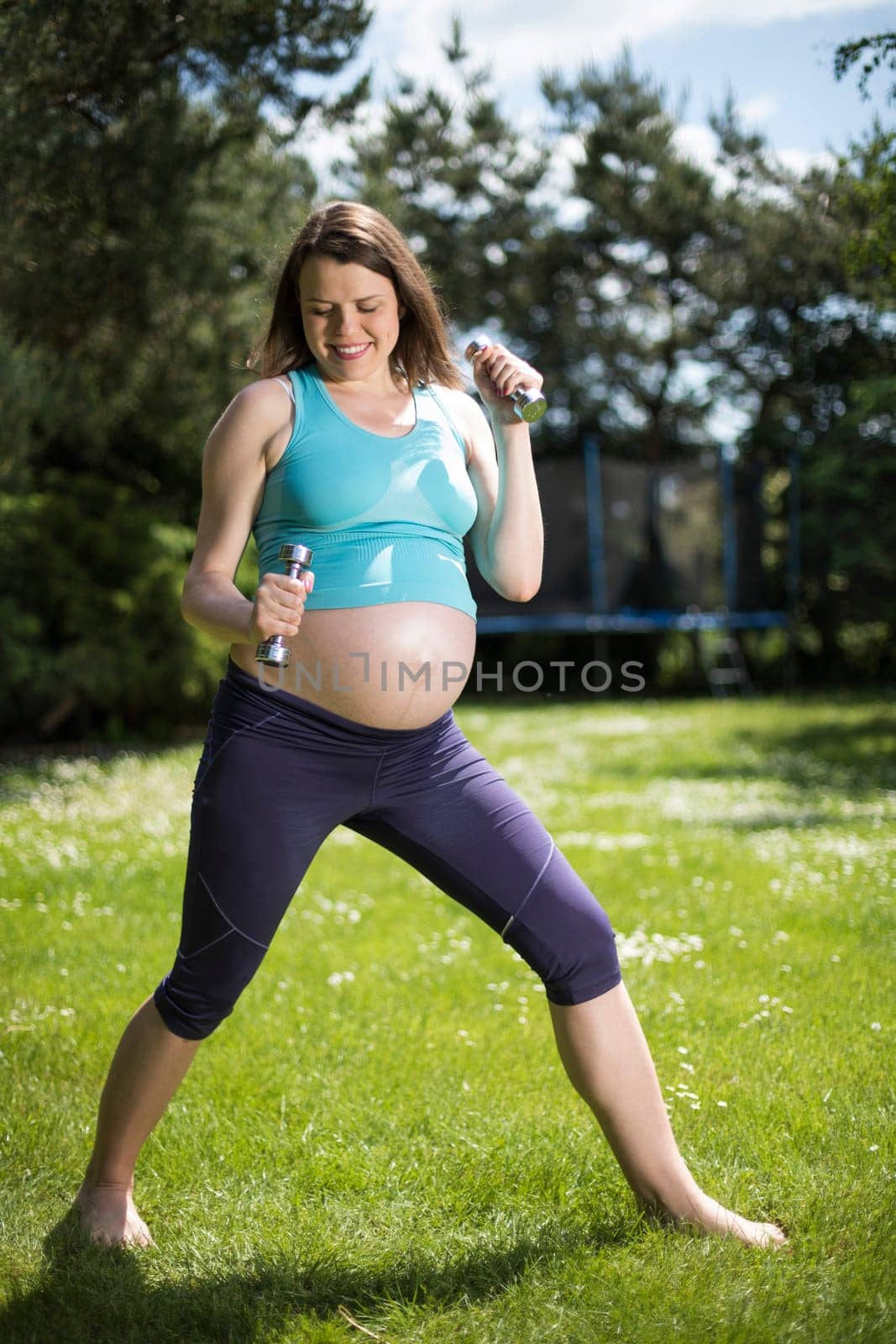 Beautiful pregnant woman at fitness gym relaxed