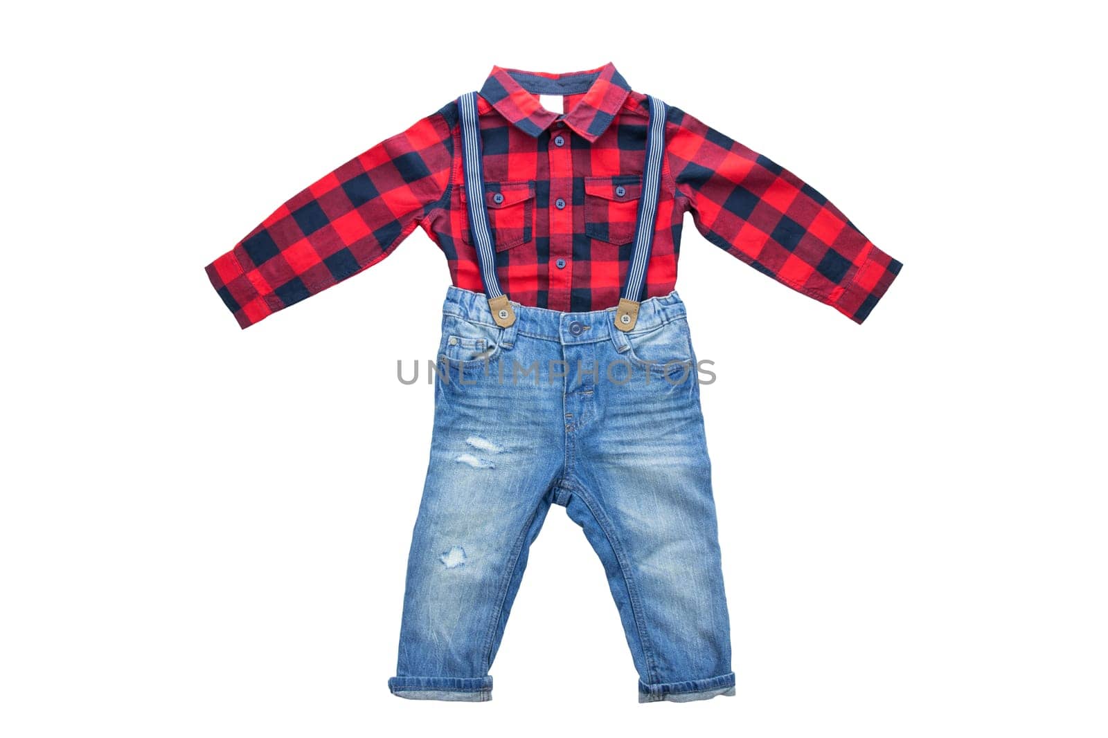 Fashionable blue jeans with braces or suspenders for boy and red checkered shirt with a long sleeve. Isolated. Children clothes.