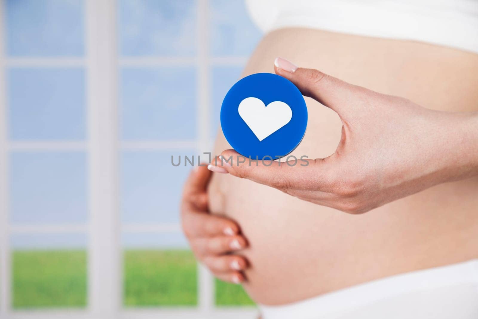 Pregnant woman holding a heart