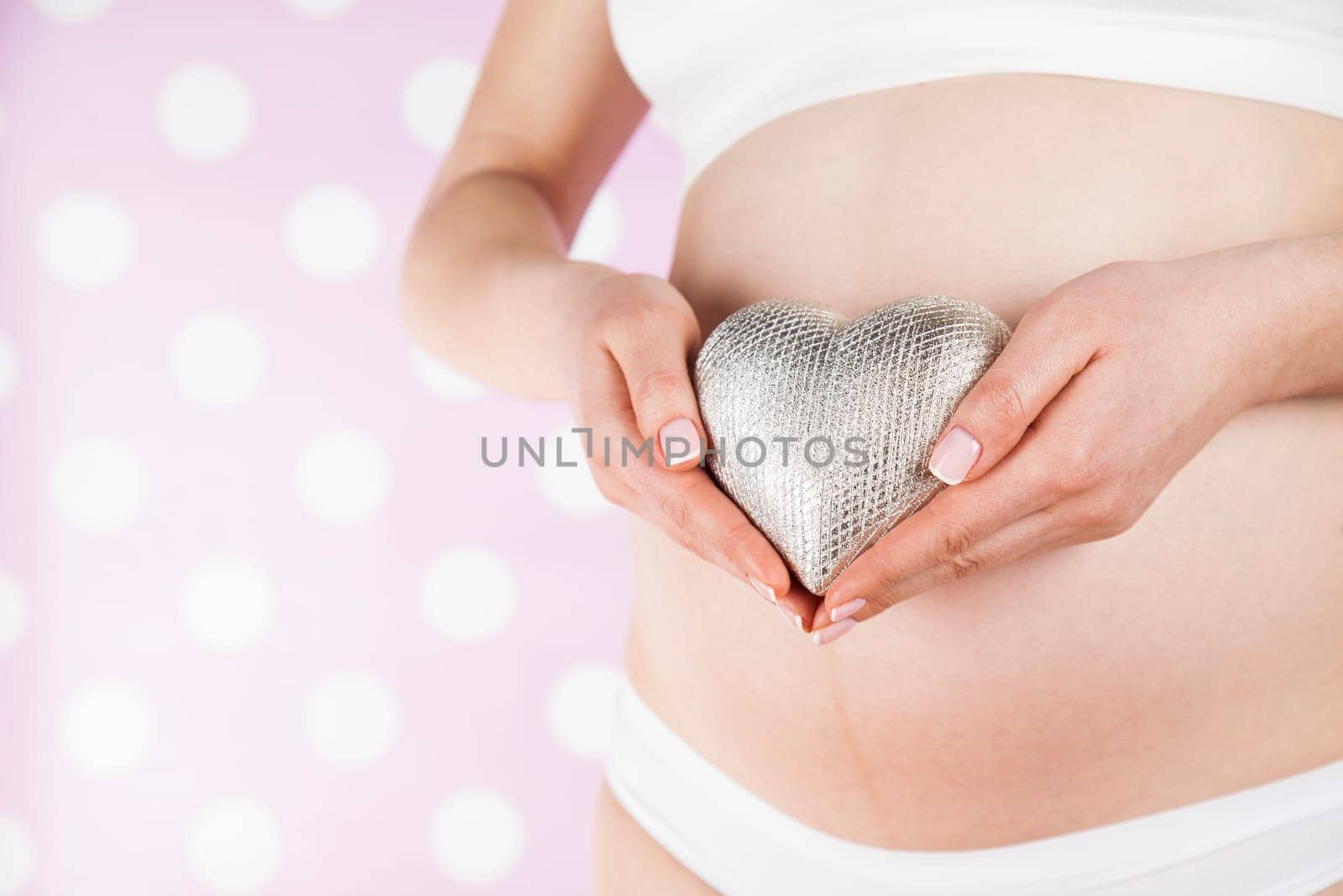 Pregnant woman holding a heart