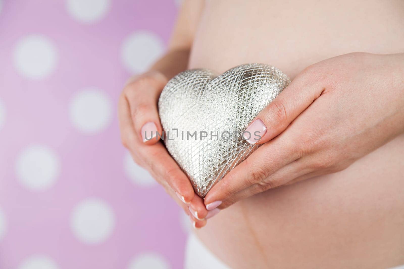 Pregnant woman holding a heart