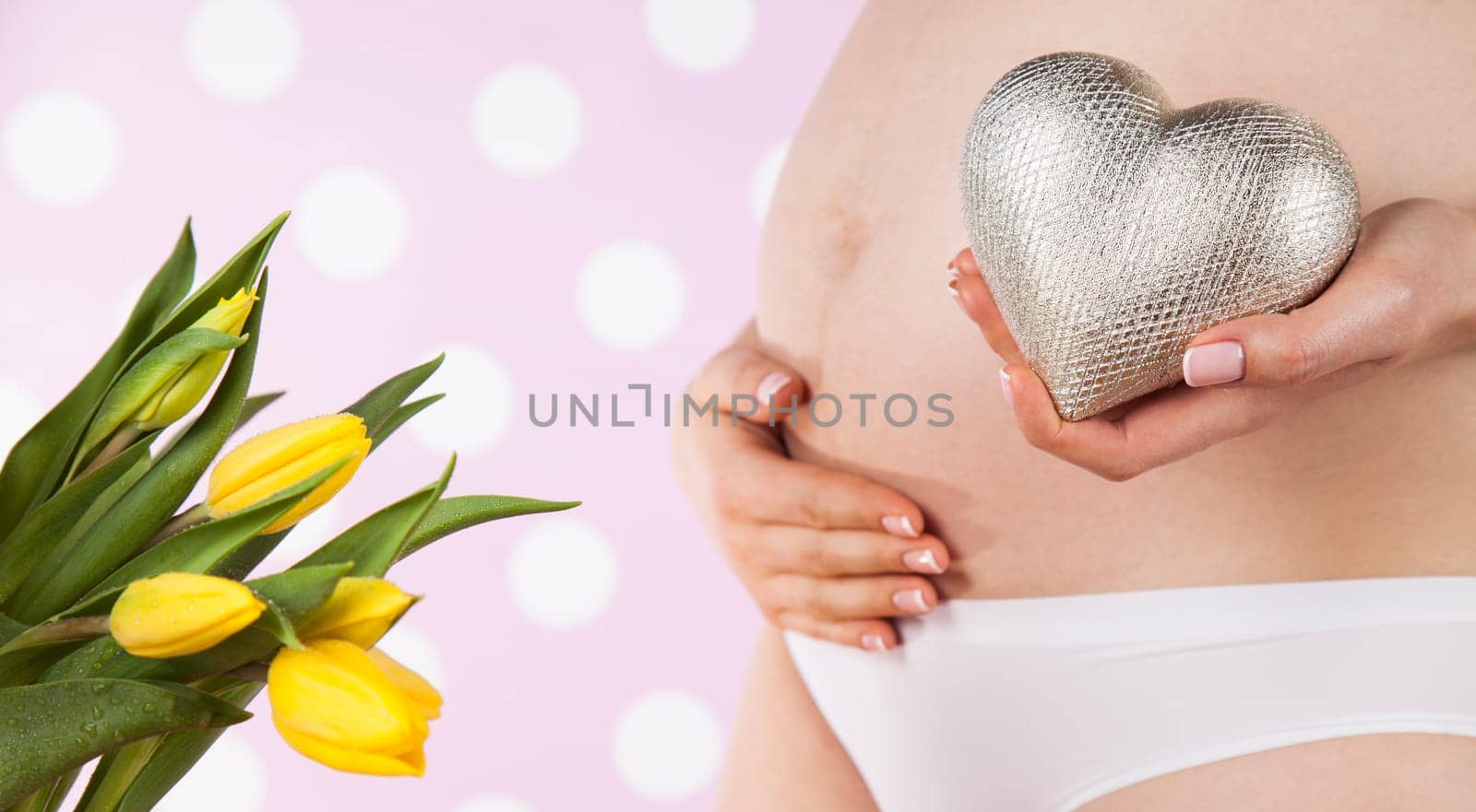Pregnant woman holding a heart
