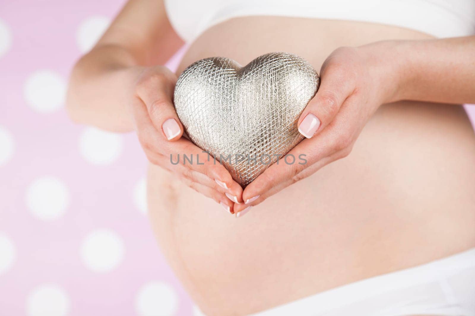 Pregnant woman holding a heart