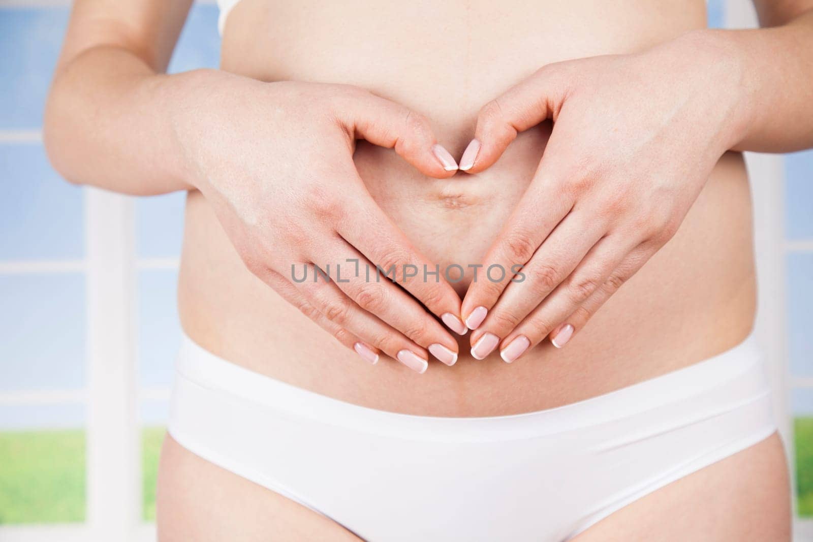 Pregnant woman holding a heart
