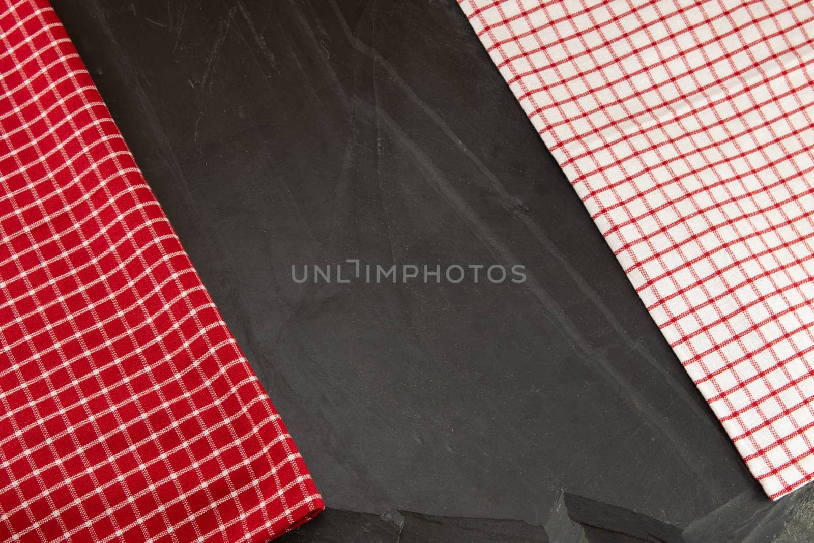 Red and white checkered tablecloth on massive slate plate. Template for design menu card and chalkboard. Space for designer.