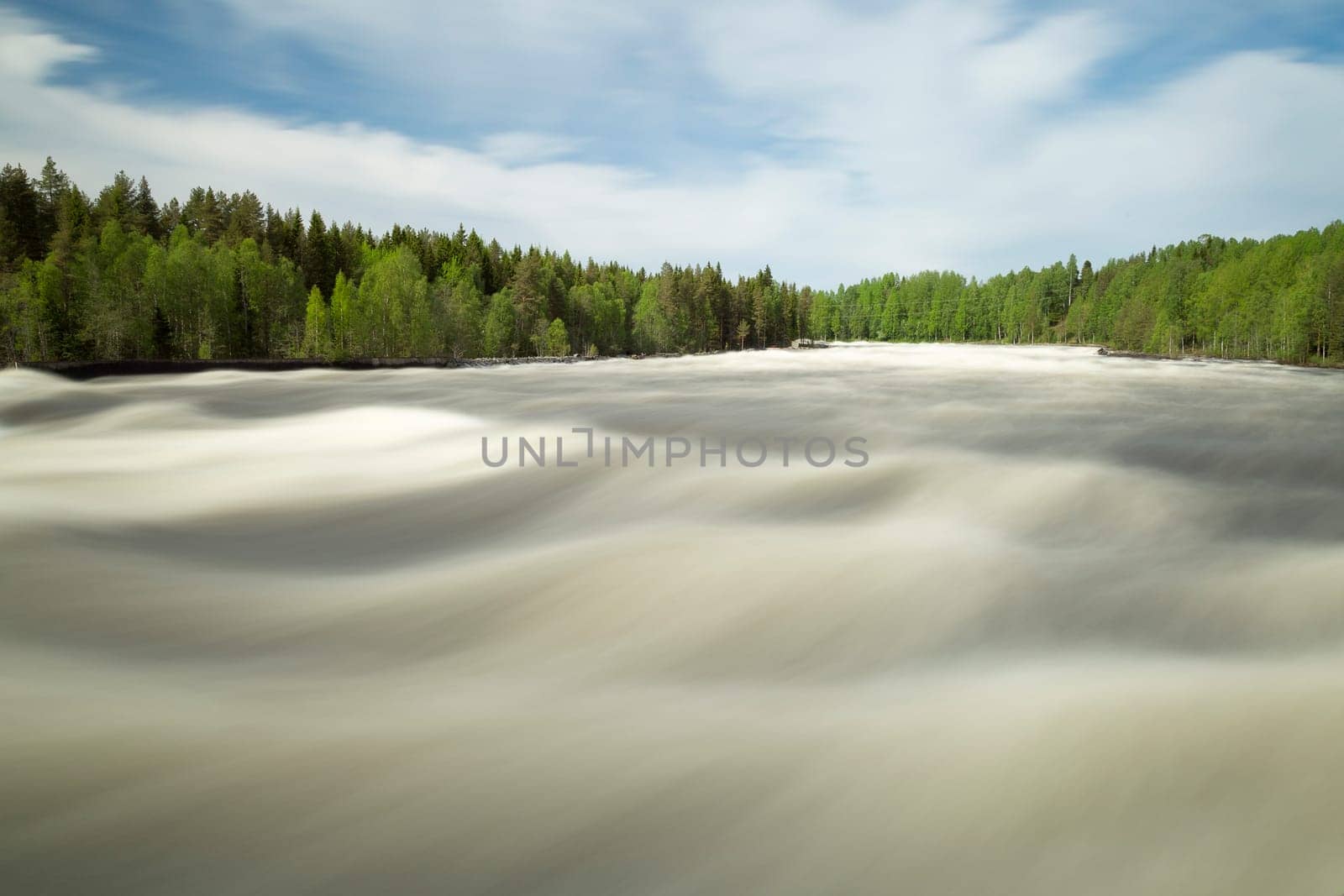 The rapids at Renforsen in Vindeln, Sweden with a partly cloudy sky.