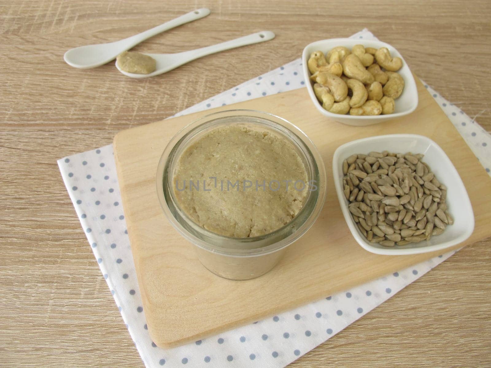 Homemade vegan nut butter from cashews and sunflower seeds in a glass