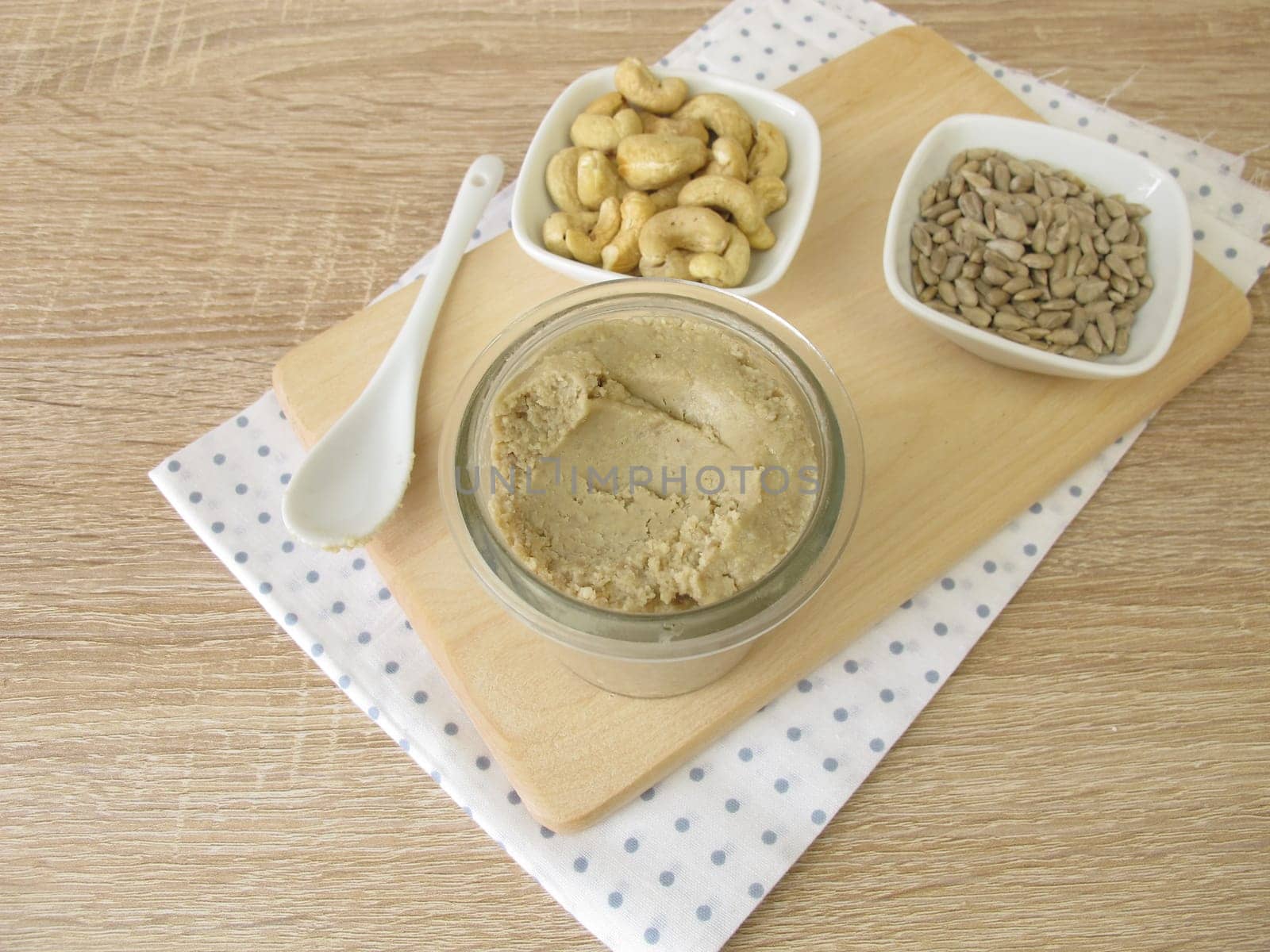 Homemade vegan nut butter from cashews and sunflower seeds in a glass
