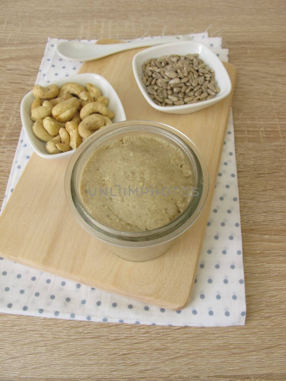 Homemade vegan nut butter from cashews and sunflower seeds in a glass
