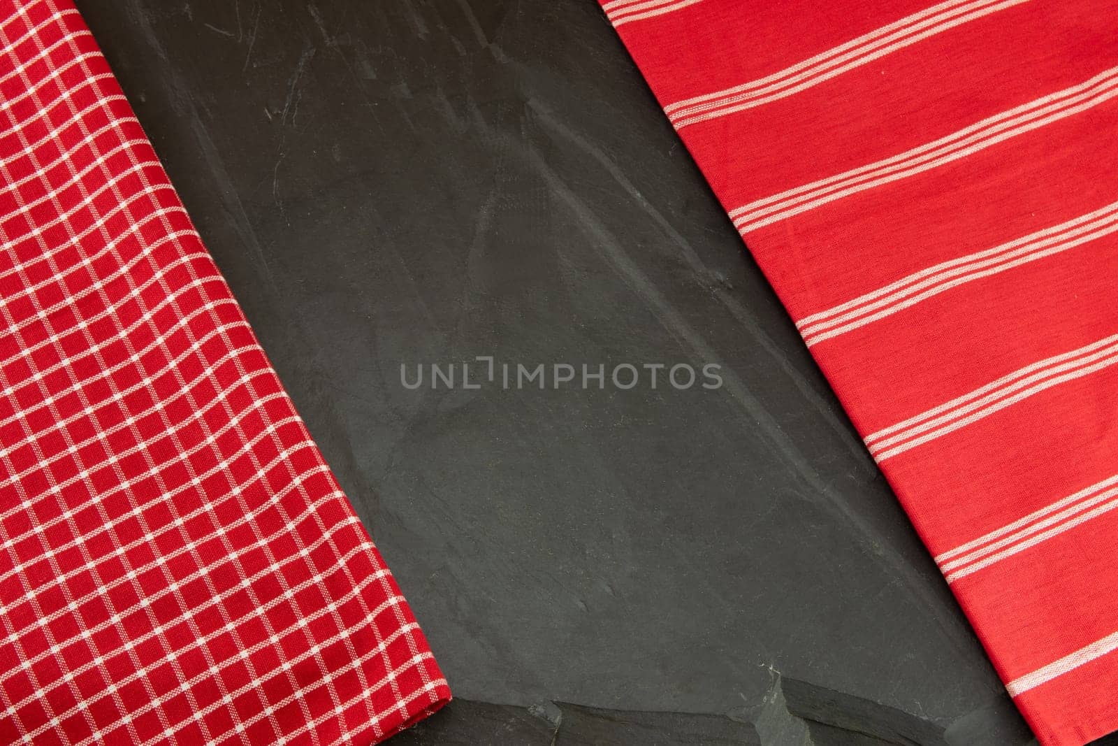 Red checkered and striped tablecloth on massive slate plate. Template for design menu card and chalkboard. Space for designer.
