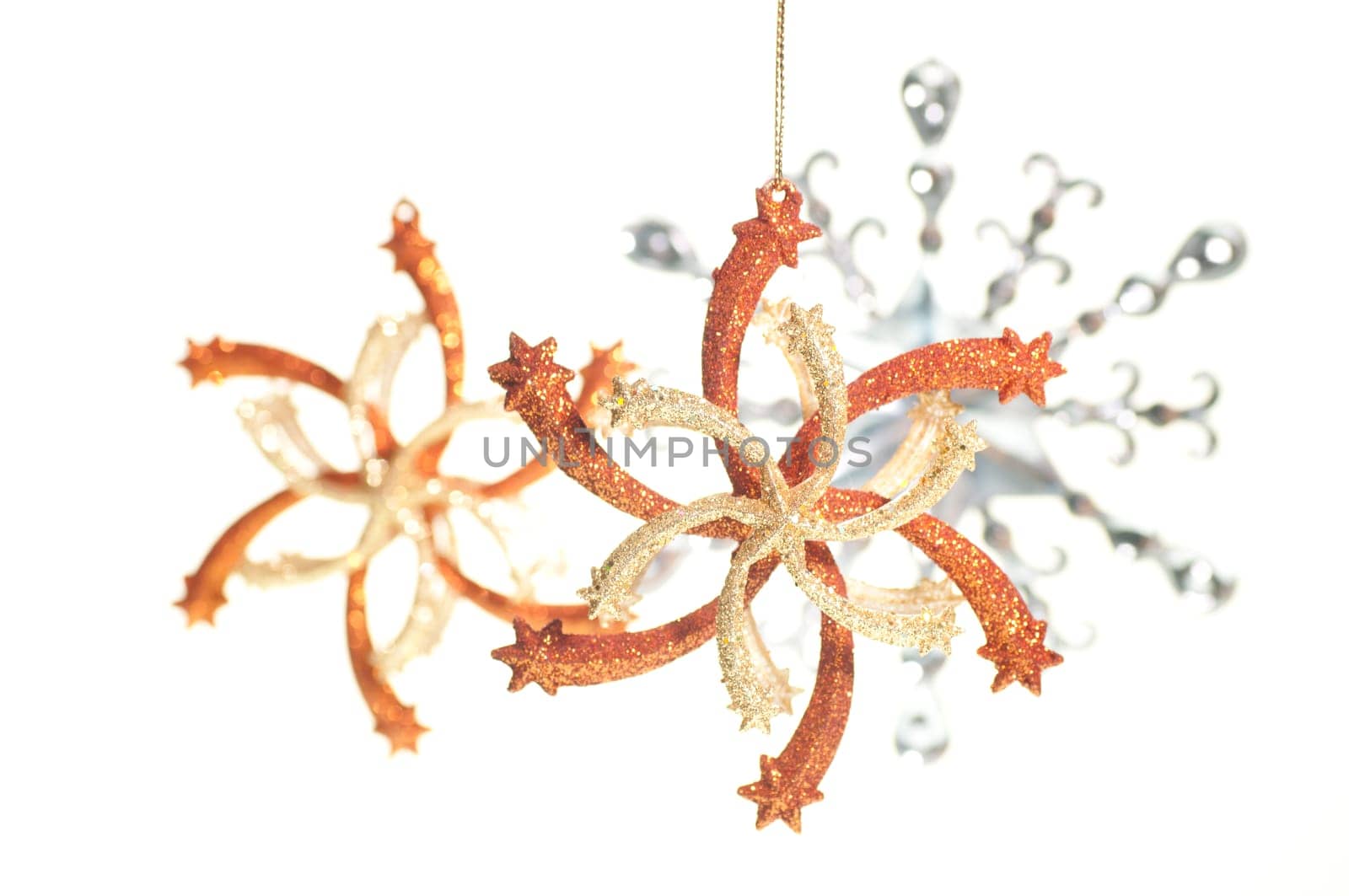 Hanging gold, silver and bronze Christmas star ornaments