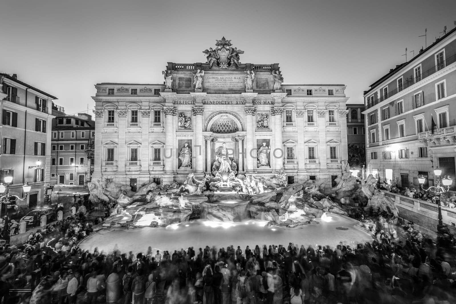 Rome Trevi Fountain or Fontana di Trevi at dusk, Rome, Italy. Trevi is the largest Baroque, most famous and visited by tourists fountain of Rome. Black and white image.