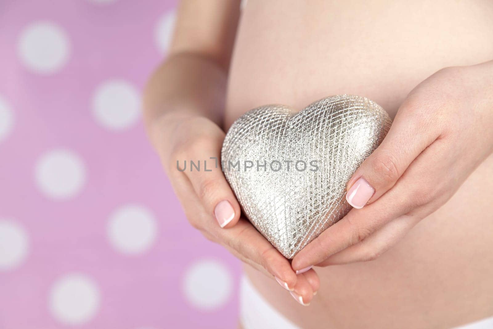 Pregnant woman holding a heart