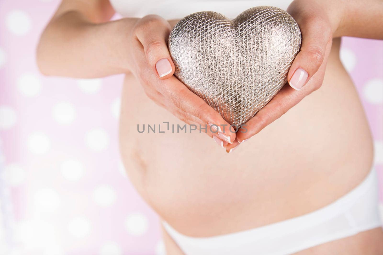 Pregnant woman holding a heart