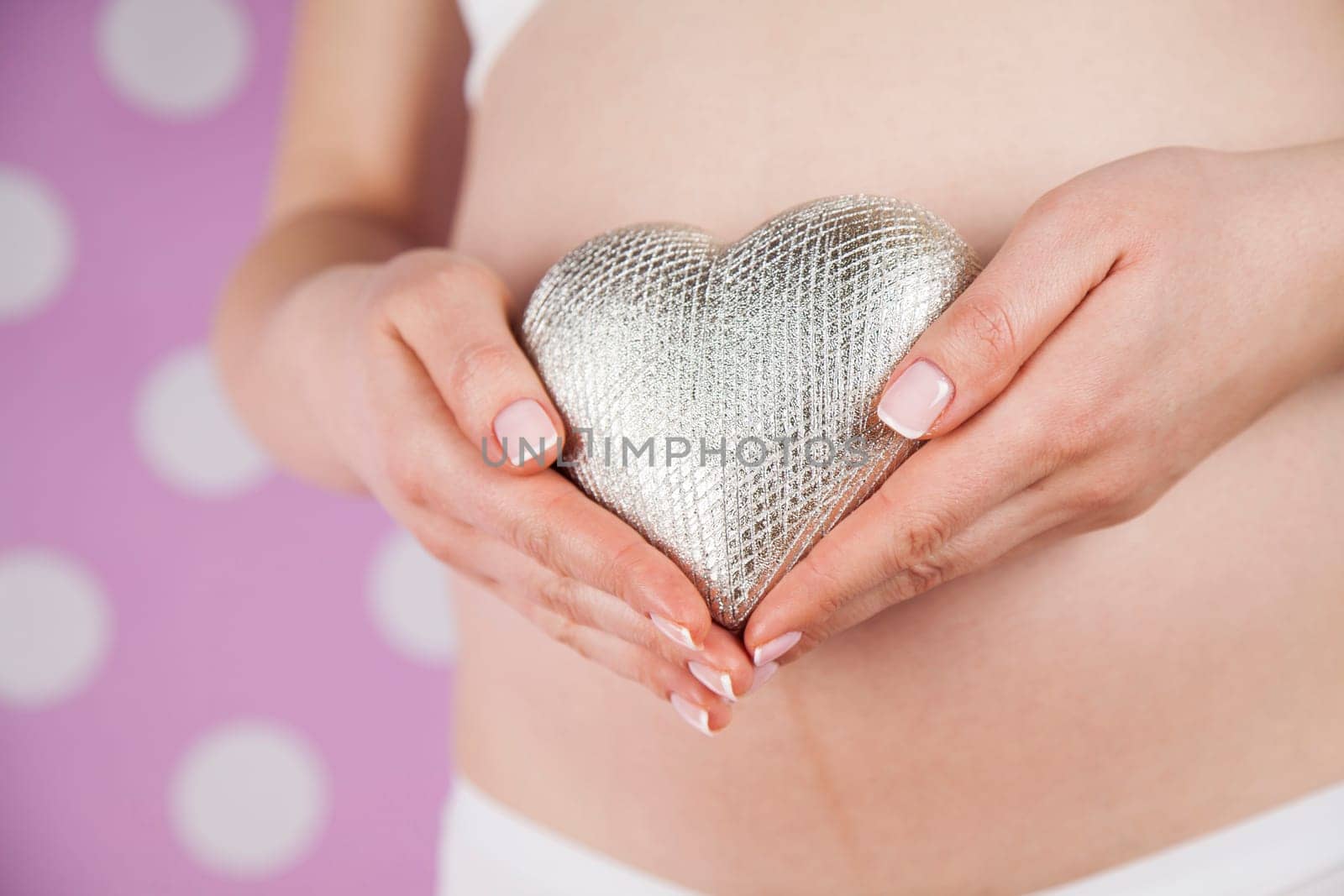 Pregnant woman holding a heart