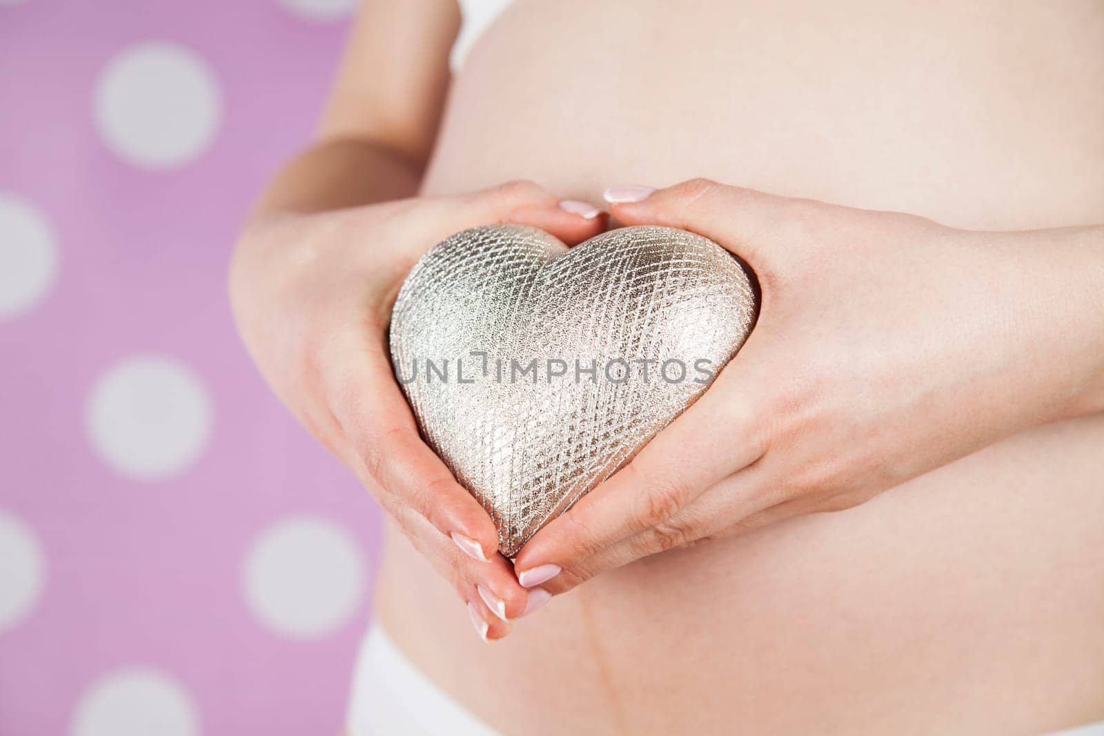 Pregnant woman holding a heart