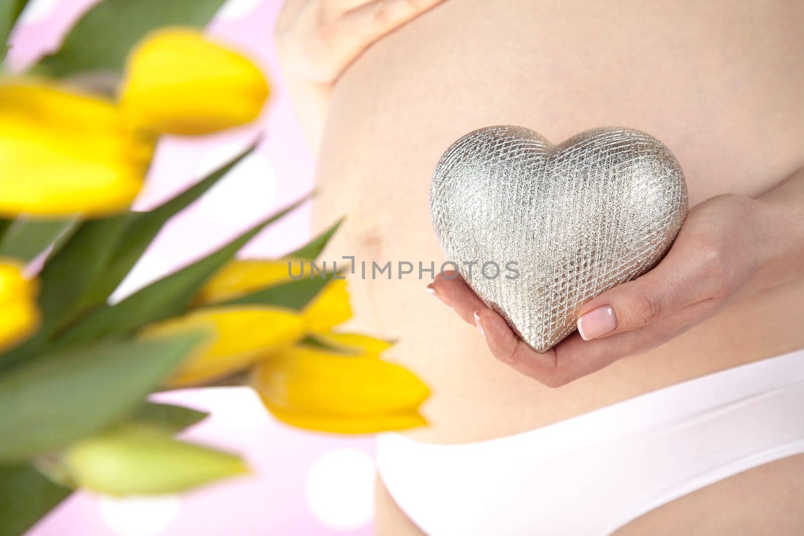Pregnant woman holding a heart