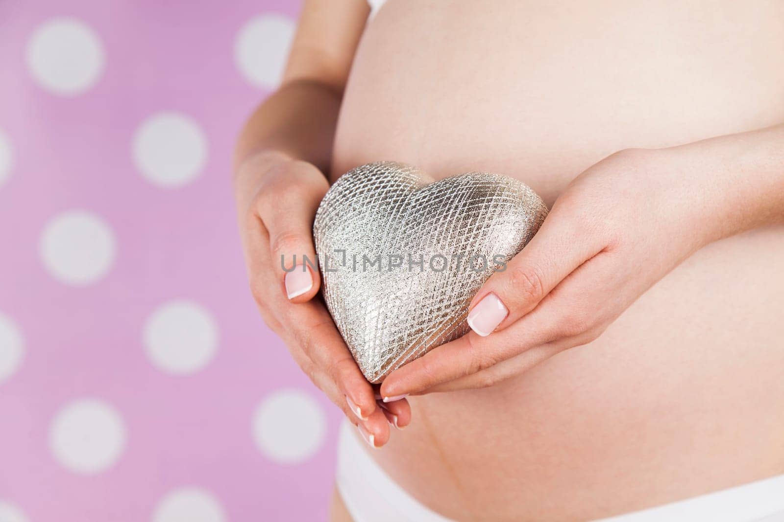 Pregnant woman holding a heart