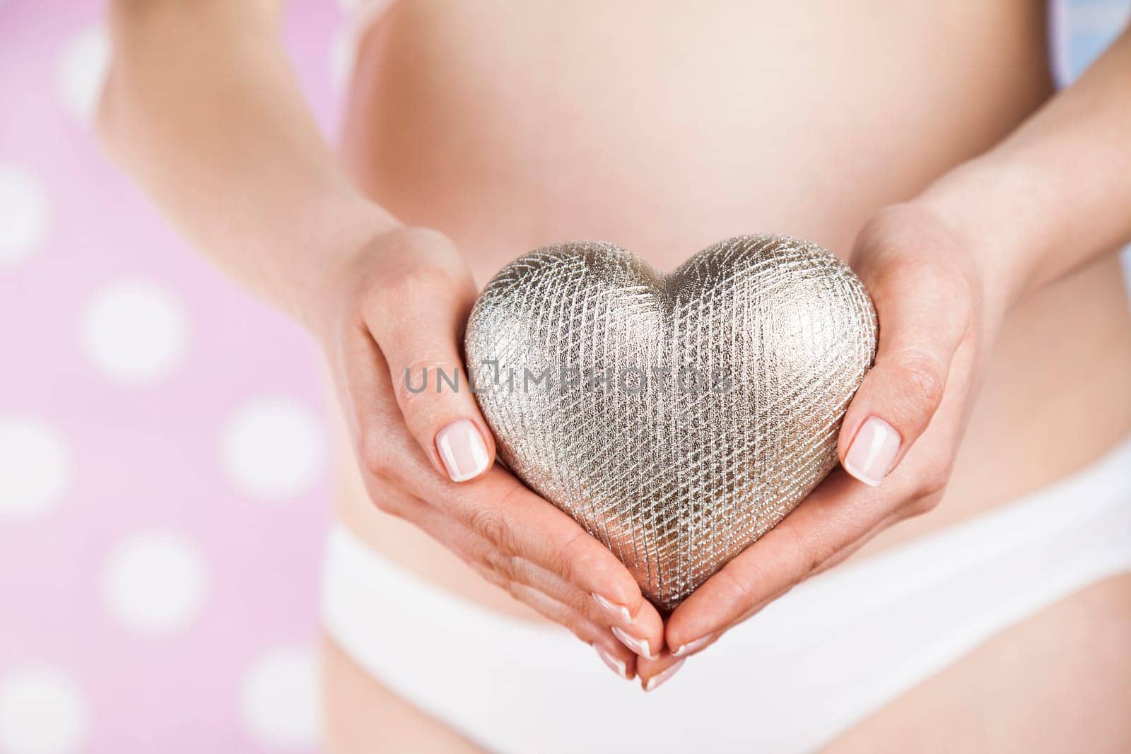 Pregnant woman holding a heart