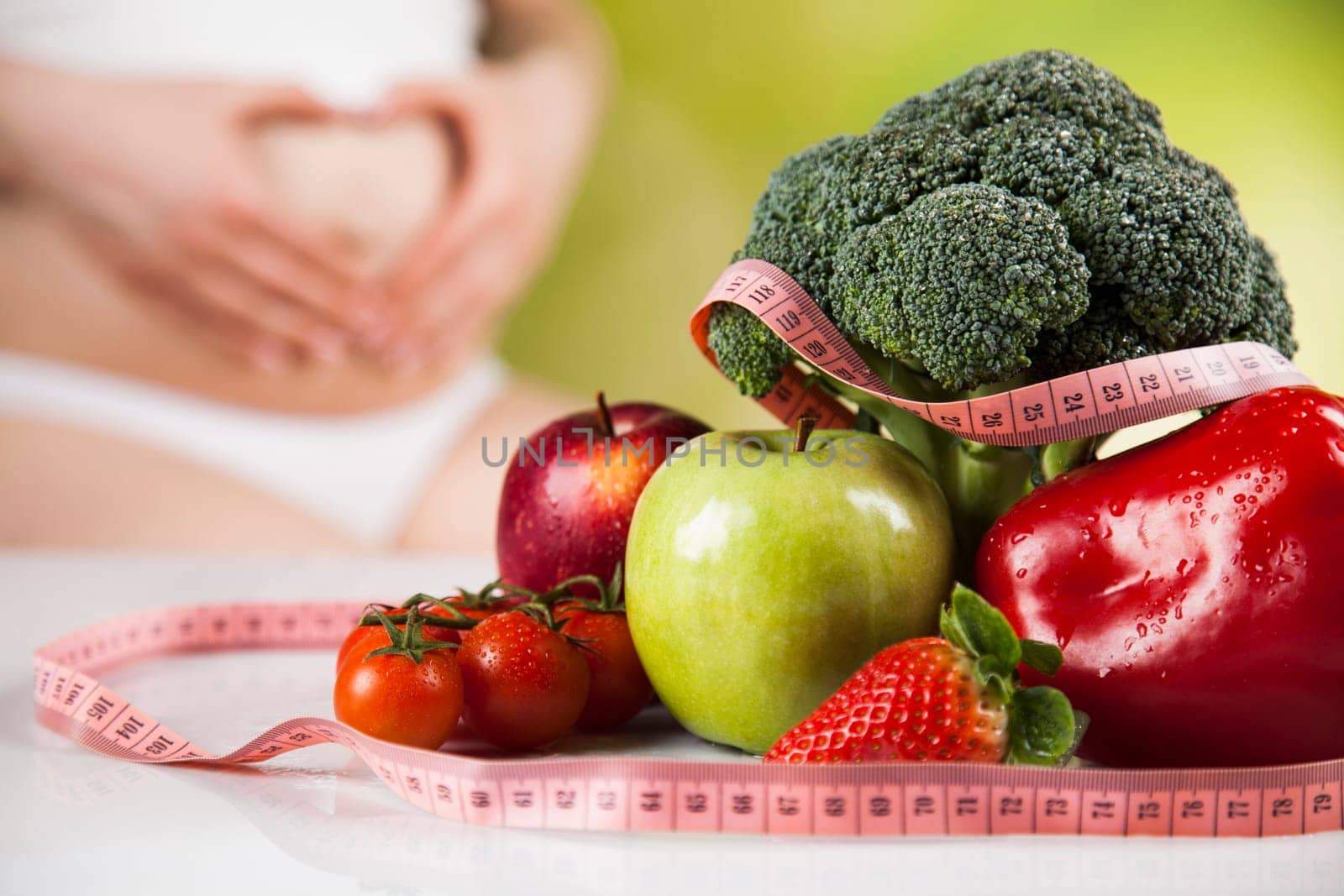 Pregnant woman with fruit and vegetables