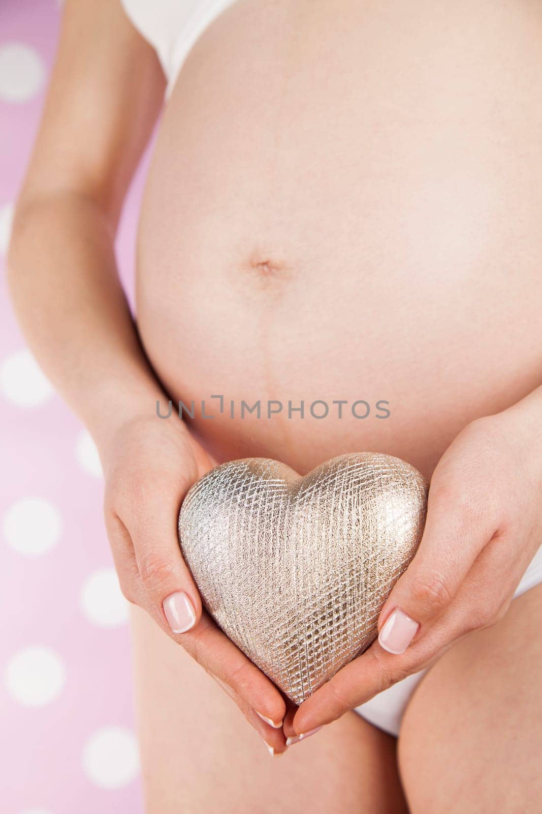 Pregnant woman holding a heart