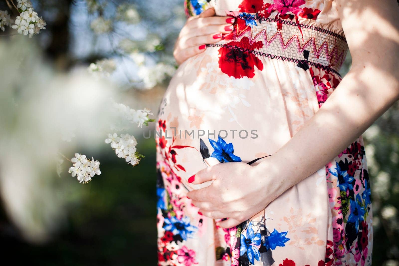 Beautiful pregnant woman relaxing outside in the Orchard