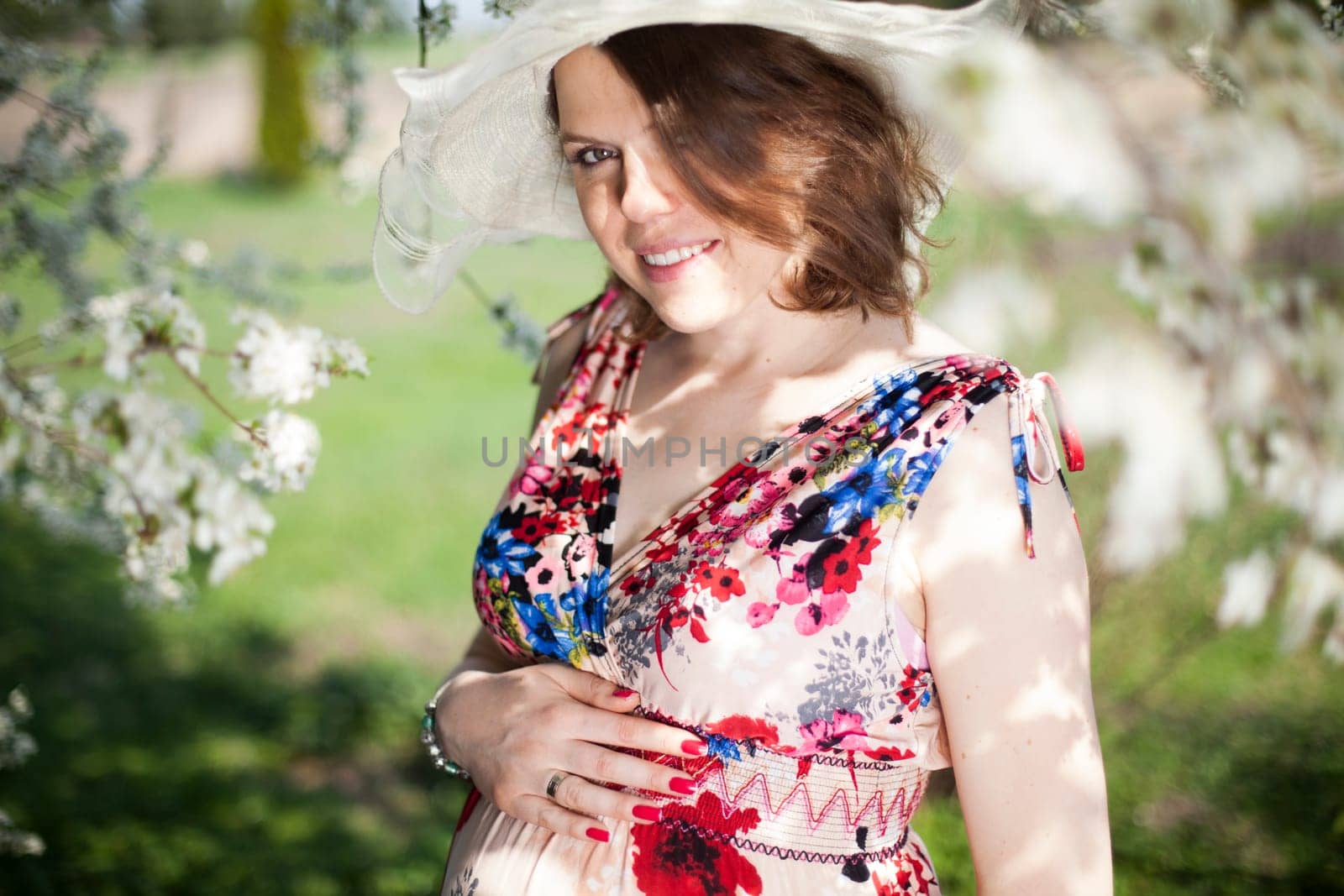 Spring, Young beautiful pregnant woman in the Orchard